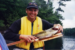 Rob Bergevin and paddle-sized Smallmouth Bass. (August, 2004 on Desert Lake)